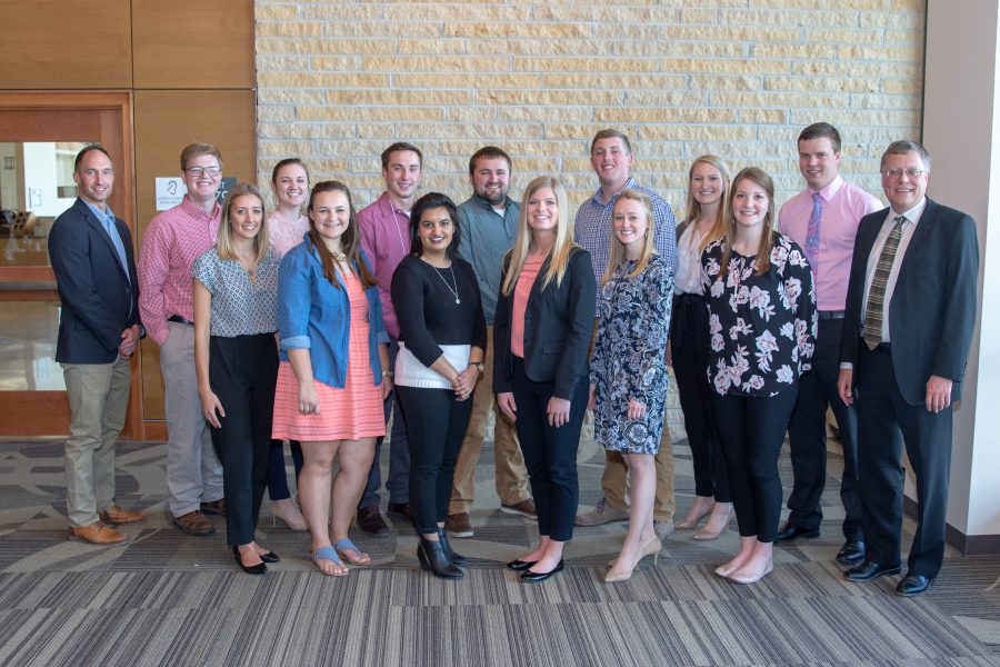students standing with faculty