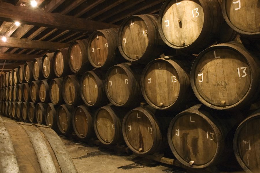 Barrels in brewery with beer waiting to be bottled