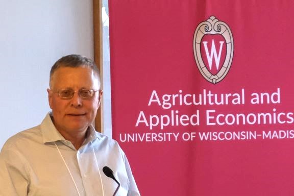 Dr. Paul Mitchell speaking at the podium